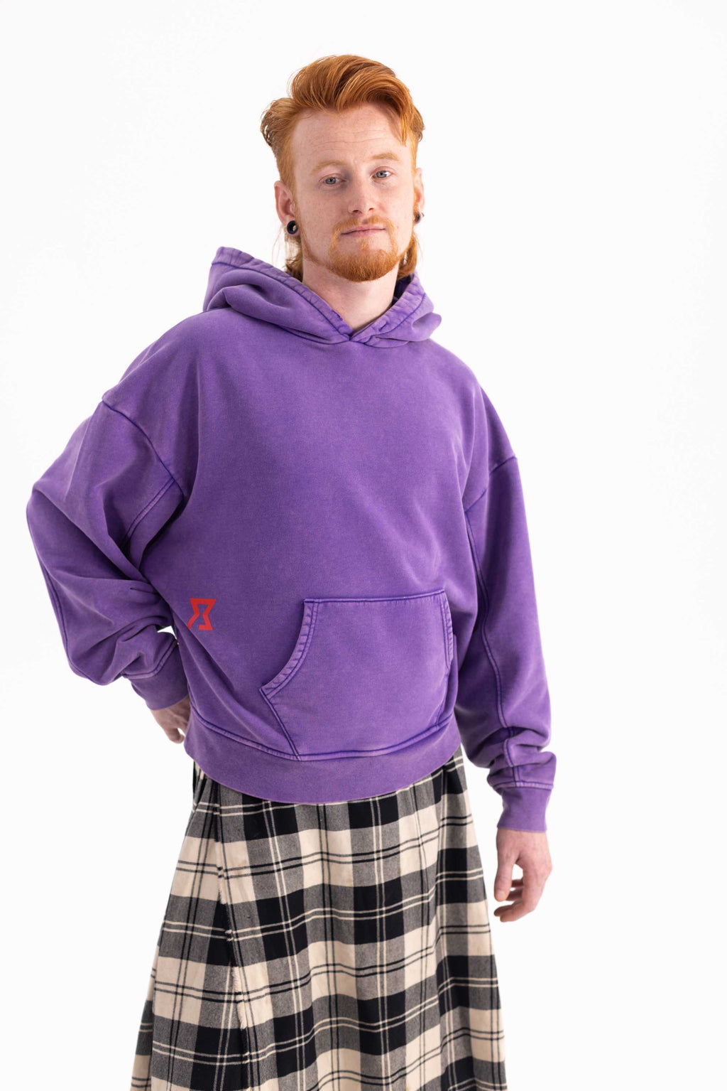 Front view of Matthijs wearing Achilles and the Tortoise  purple hoodie with focus on logo and pouch detail on front. Amsterdam sustainable streetwear.