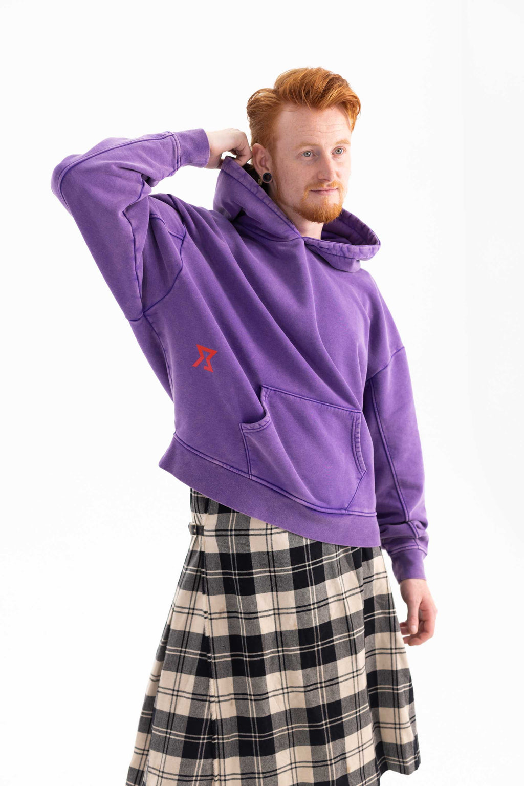 Side view of Matthijs wearing Achilles and the Tortoise purple hoodie. Amsterdam sustainable streetwear.